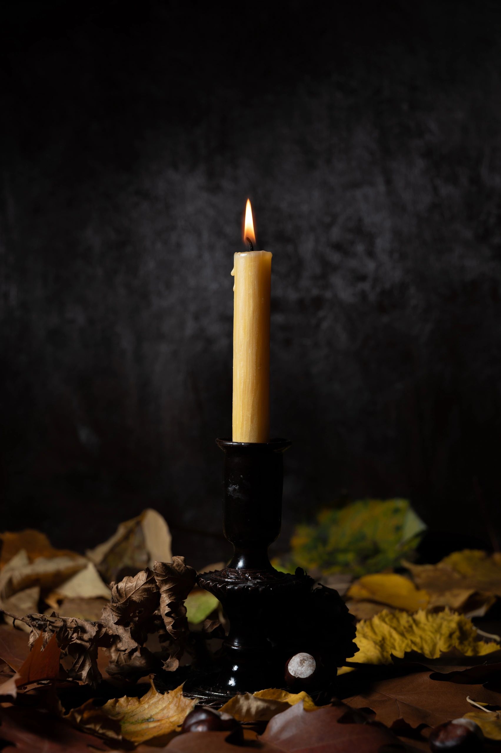Burning candle in dark setting
